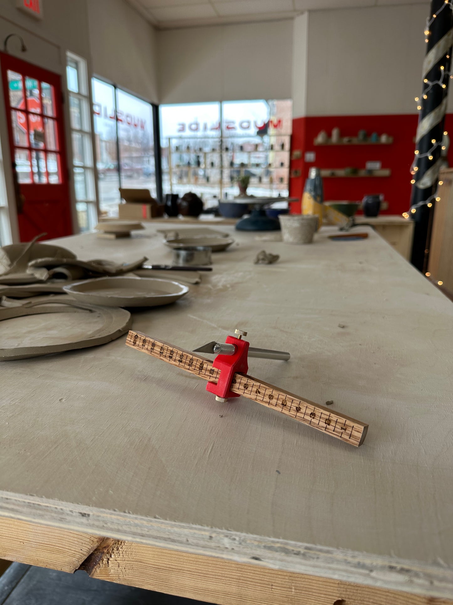 height gauge tool with xacto knife on a table