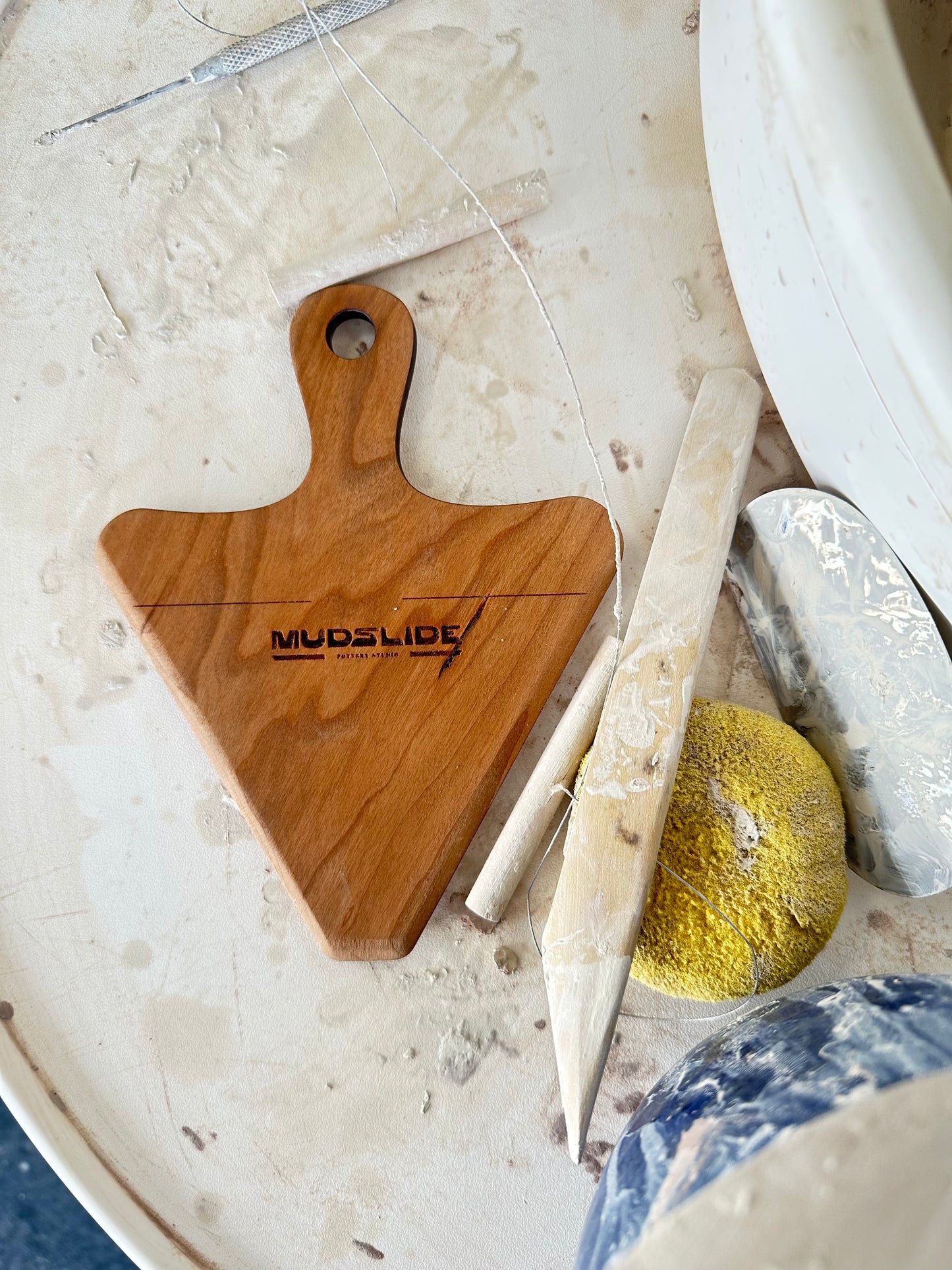 wooden pour over tool sitting on a pottery wheel